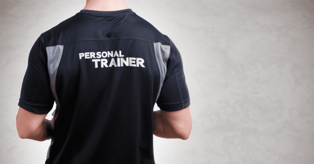 Man facing away, wearing a t-shirt that says "personal trainer".