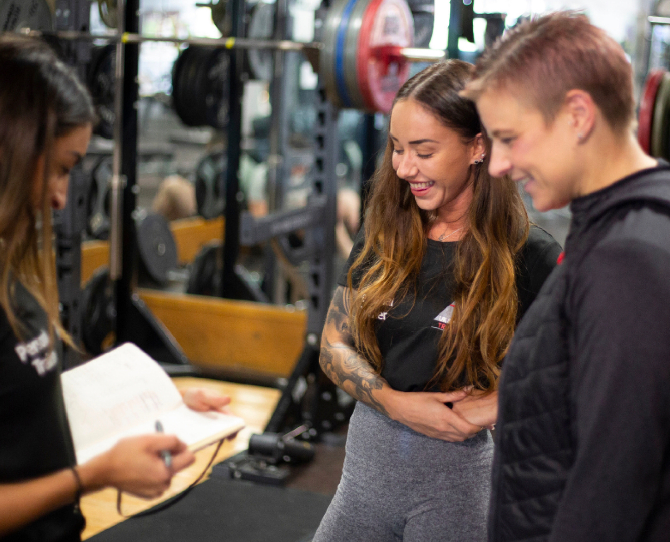 An instructor teaching two people on a fitness instructor course.